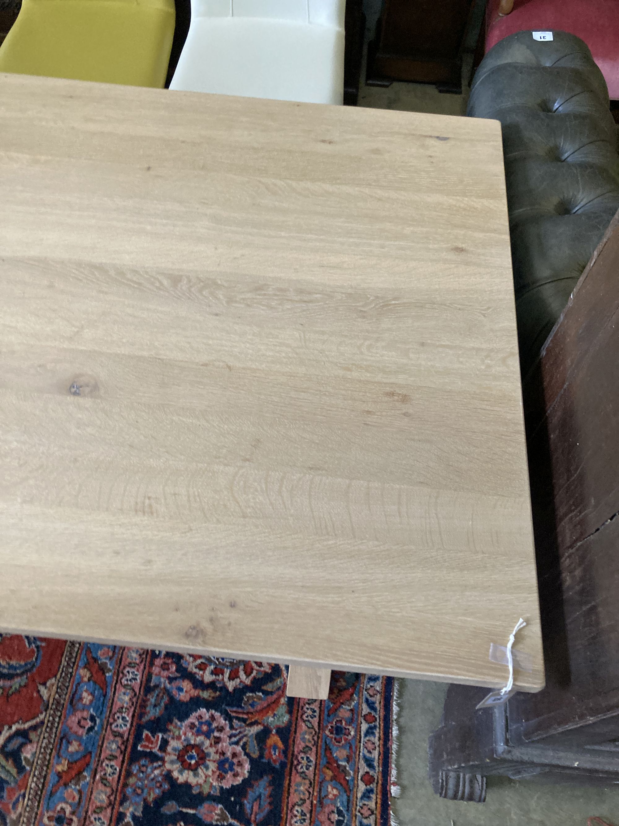 A contemporary oak X-framed dining table, length 200cm, depth 100cm, height 76cm